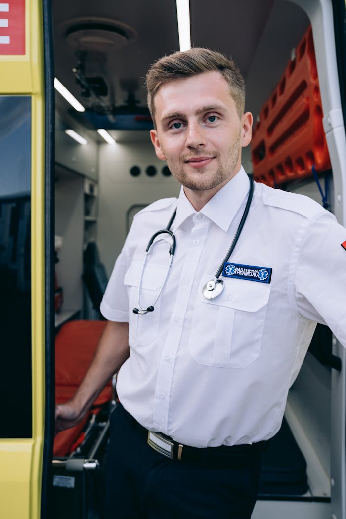 Confident paramedic standing at ambulance door, ready for action.